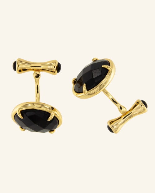 Golden astronaut cufflinks with onyx